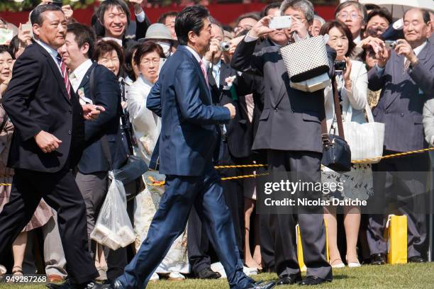 Japan Prime Minister Shinzo Abe walks during a government garden party in Shinjuku Gyoen park on April 21, 2018 in Tokyo, Japan. Shinzo Abe and his...