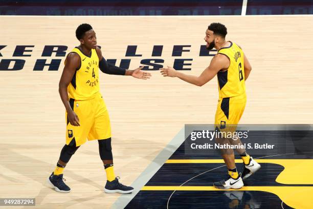 Cory Joseph and Victor Oladipo of the Indiana Pacers high five during the game against the Cleveland Cavaliers in Game Three of Round One of the 2018...