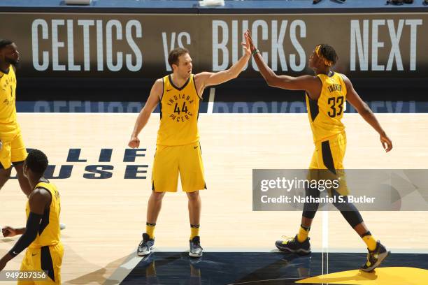 Myles Turner and Bojan Bogdanovic of the Indiana Pacers high five during the game against the Cleveland Cavaliers in Game Three of Round One of the...