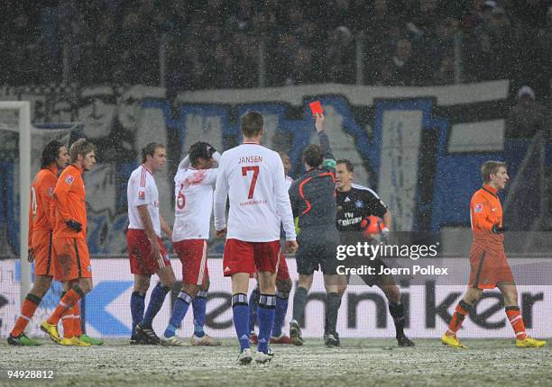 Referee Florian Meyer shows the red card to Jerome Boateng of Hamburg ball during the Bundesliga match between Hamburger SV and Werder Bremen at HSH...