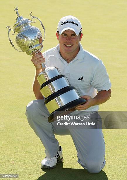 Richie Ramsay of Scotland poses with the trophy after winning the South African Open Championship after a play-off against Shiv Kapur of India at...