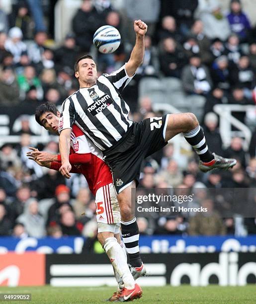 Steven Taylor heads the ball under a challenge from Rhys Williams during the Coca-Cola championship match between Newcastle United and Miiddlesbrough...