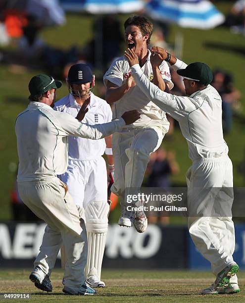 Friedel de Wet of South Africa celebrates with team-mates after taking the wicket of Matt Prior of England for no runs during day five of the first...