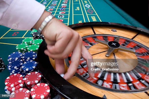 croupier at roulette table - roulette dealer stock pictures, royalty-free photos & images