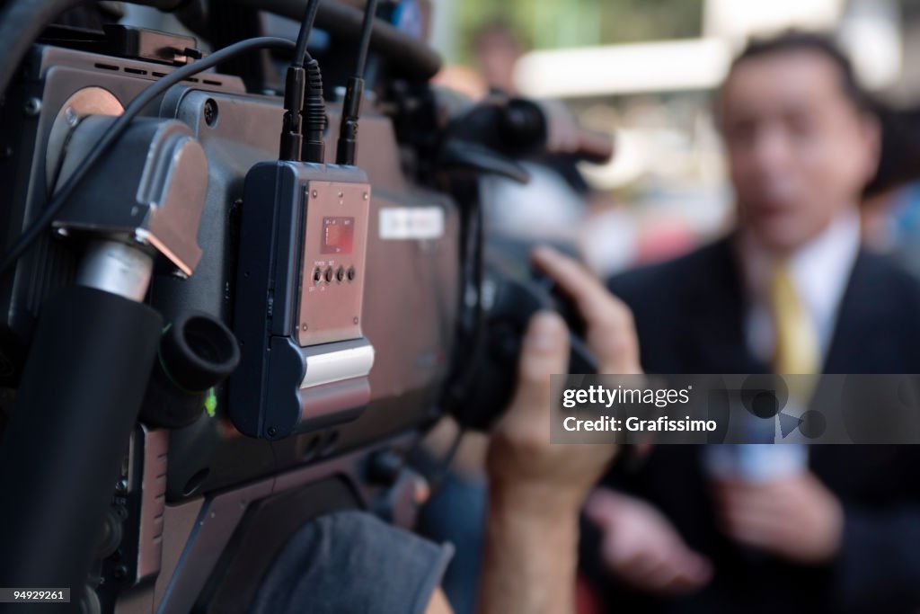 Cameraman filming a reporter