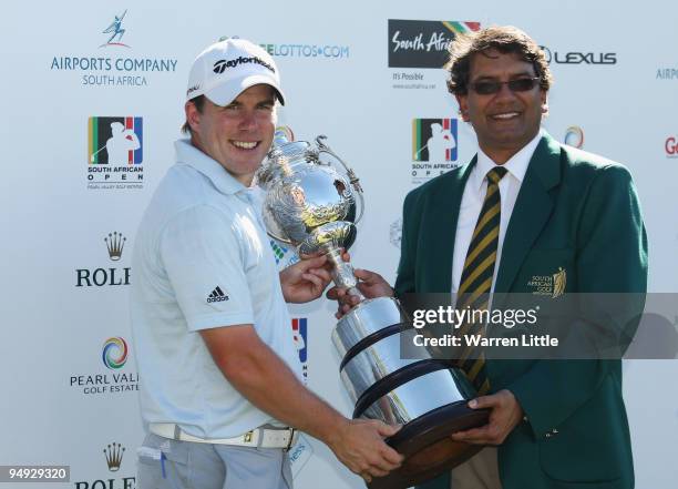 Richie Ramsay of Scotland is awarded the trophy by Enver Hassen President of the South African Golf Association after winning the South African Open...