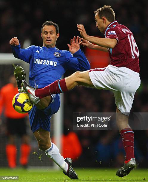 Ricardo Carvalho of Chelsea challenges Mark Noble of West Ham United during the Barclays Premier League match between West Ham United and Chelsea at...