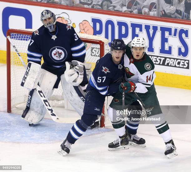 Tyler Myers of the Winnipeg Jets battles Joel Eriksson Ek in Game Five of the Western Conference First Round during the 2018 NHL Stanley Cup Playoffs...