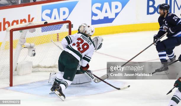 Shot by Blake Wheeler of the Winnipeg Jets hits the crossbar behind Nate Prosser and Alex Stalock of the Minnesota Wild in Game Five of the Western...