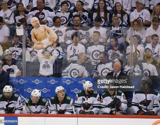 Young fan of the Winnipeg Jets taunts head coach Bruce Boudreau of the Minnesota Wild in Game Five of the Western Conference First Round during the...