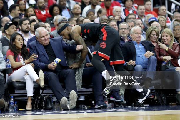 Lorenzo Brown of the Toronto Raptors runs into the crowd going after a loose ball against the Washington Wizards in the second half during Game Three...