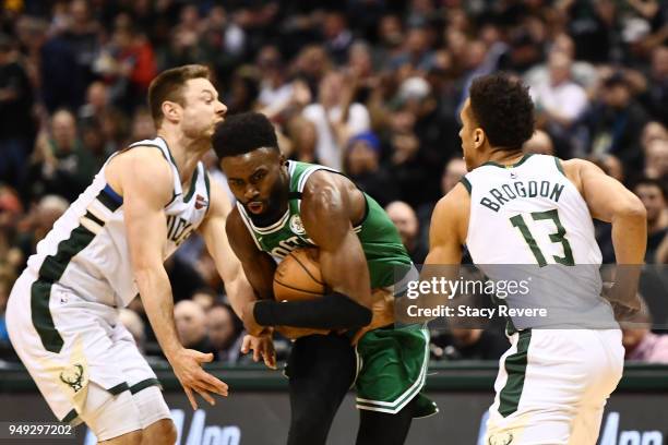 Jaylen Brown of the Boston Celtics drives to the basket against Matthew Dellavedova and Malcolm Brogdon of the Milwaukee Bucks during the first half...