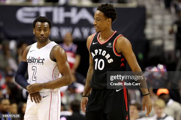 John Wall of the Washington Wizards talks with DeMar DeRozan of the Toronto Raptors in the second half during Game Three of Round One of the 2018 NBA...