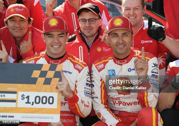 Scott McLaughlin driver of the Shell V-Power Racing Team Ford Falcon FGX celebrates with his team mate Fabian Coulthard driver of the Shell V-Power...
