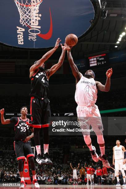 Ty Lawson of the Washington Wizards and Lorenzo Brown of the Toronto Raptors reach for the ball during the game between the two teams in Game Three...