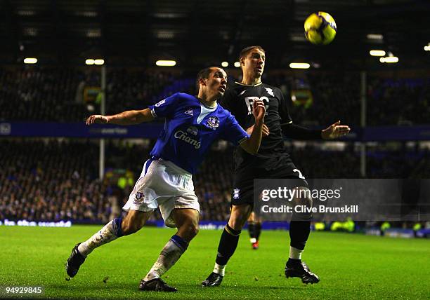 Leon Osman of Everton competes for the ball with Gregory Vignal of Birmingham City during the Barclays Premier League match between Everton and...