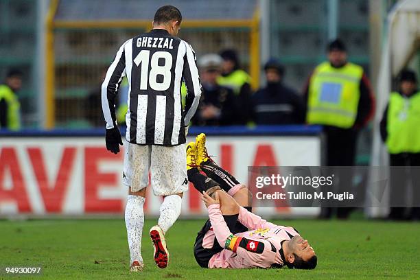 Abdelkader Ghezzal walks over to Palermo teammate Fabrizio Miccoli as he lies injured on the ground during the Serie A match between US Citta di...