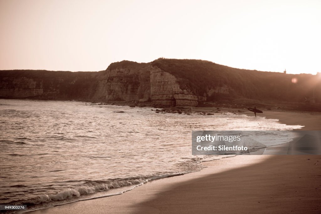 Surfer Contemplating Ocean On Empty Beach, California Coast