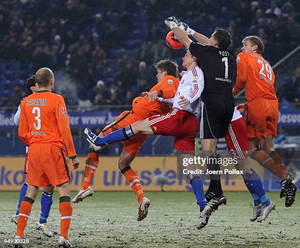 Sebastian Proedl and Per Mertesacker of Bremen and Frank Rost and Marcell Jansen and David Rozehnal of Hamburg battle for the ball during the...