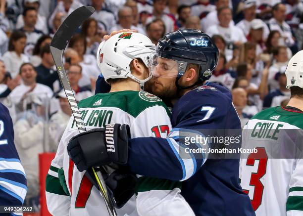 Marcus Foligno of the Minnesota Wild and Ben Chiarot of the Winnipeg Jets embrace following a 5-0 Jets victory in Game Five of the Western Conference...
