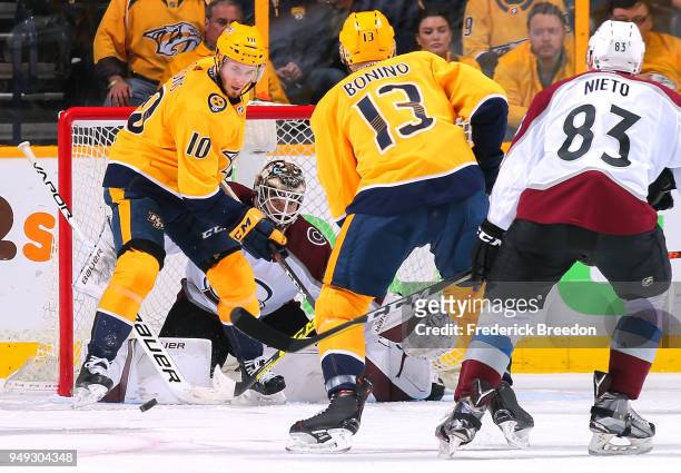 Colton Sissons of the Nashville Predators tries to deflect a puck in front of goalie Andrew Hammond of the Colorado Avalanche during the second...