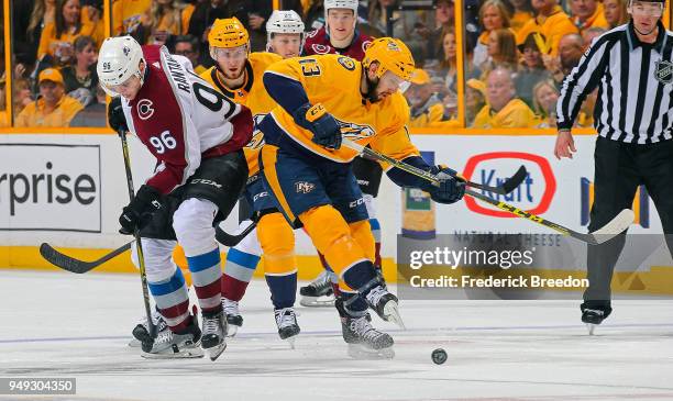 Nick Bonino of the Nashville Predators kicks the puck away from Mikko Rantanen of the Colorado Avalanche during the second period in Game Five of the...