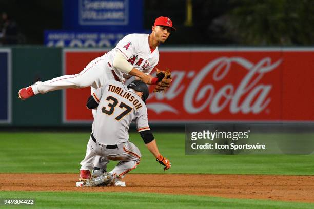 San Francisco Giants infielder Kelby Tomlinson slides hard into Los Angeles Angels shortstop Andrelton Simmons , but Simmons is able to turn the...