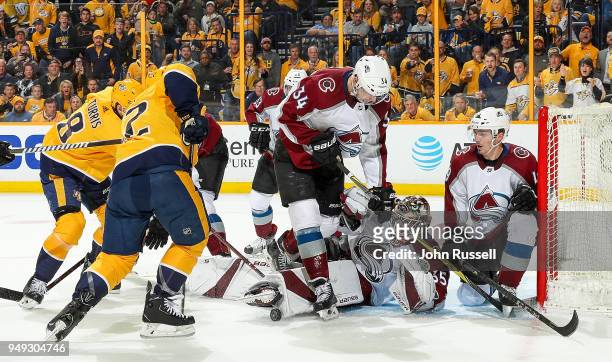 Andrew Hammond of the Colorado Avalanche makes the save against Kevin Fiala of the Nashville Predators as Carl Soderberg and Samuel Girard defend in...