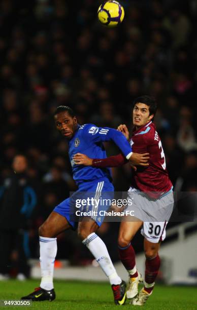 Didier Drogba of Chelsea and James Tomkins of West Ham United challenge for the ball during the Barclays Premier League match between West Ham United...