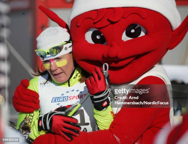 The mascot solaces the disappointed Petra Majdic of Slovenia during the Women's 15km Mass Start in the FIS Cross Country World Cup on December 20,...