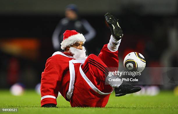 Ball juggler dressed as Father Christmas displays his skills at half time during the Barclays Premier League match between West Ham United and...