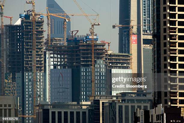 Cranes tower over buildings under construction in Dubai, United Arab Emirates, on Sunday, Nov. 23, 2008. Dubai's focus on financial services, luxury...