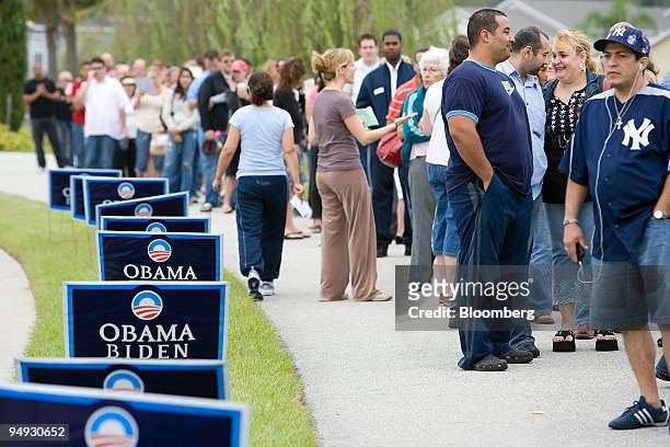 Voters wait in line to cast their ballots in the U.S. Presidential election at a polling station in Orlando, Florida, U.S., on Tuesday, Nov. 4, 2008....