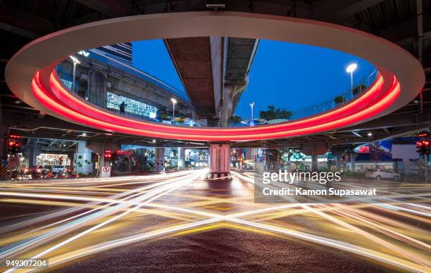 colorful light trail under mbk sky walk intersection - urban square city night stock-fotos und bilder