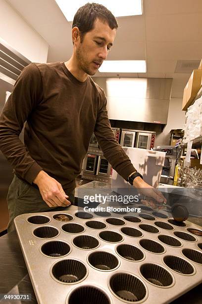 Charles Nelson, co-owner of Sprinkles Cupcakes, pours mix into a baking mold at one of his stores in Palo Alto, California, U.S., on Monday, Oct. 20,...