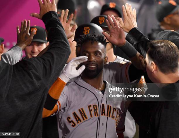 Andrew McCutchen of the San Francisco Giants is greeted in the dugout after a three run home run in the fifth inning of the game against the Los...