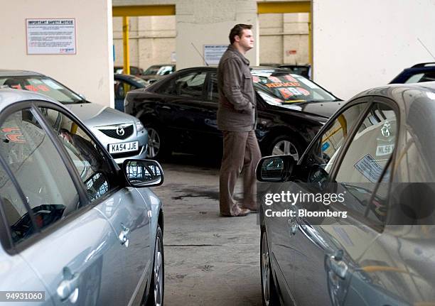 Customer browses second-hand vehicles for sale at a car dealership in London, U.K., on Tuesday, Nov. 4, 2008. British care sales are likely to show...
