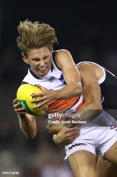 Lachie Whitfield of the Giants is tackled by Maverick Weller of the Saints during the round five AFL match between the St Kilda Saints and the...