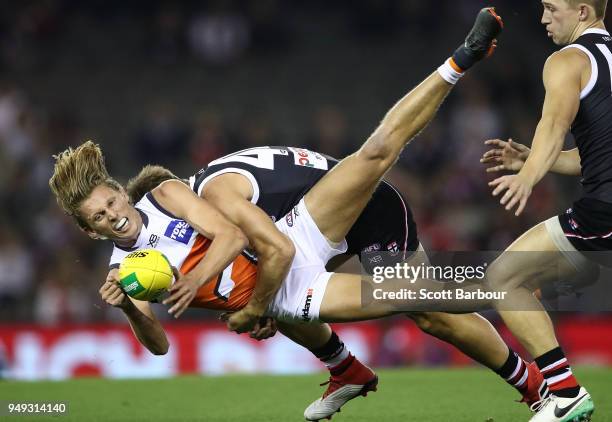 Lachie Whitfield of the Giants is tackled by Maverick Weller of the Saints during the round five AFL match between the St Kilda Saints and the...