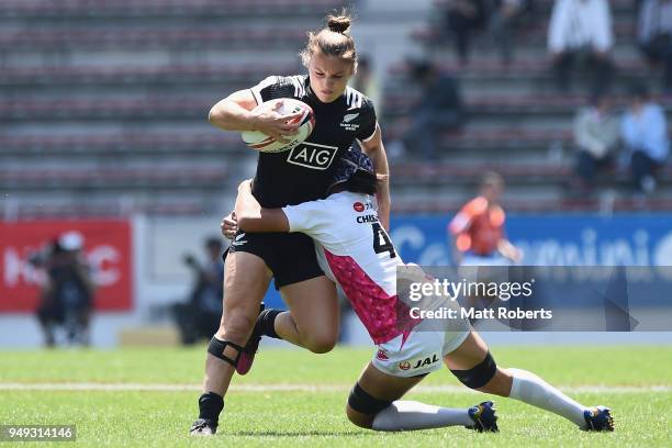 Michaela Blyde of New Zealand is tackled by Chisato Yokoo of Japan on day one of the HSBC Women's Rugby Sevens Kitakyushu Pool match between New...