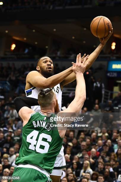 Jabari Parker of the Milwaukee Bucks drives to the basket against Aron Baynes of the Boston Celtics during the second half of game three of round one...