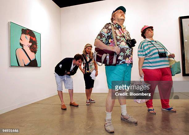 Phil Dubrovsky of Toronto, left, and his mother Elaine Dubrovsky of Montreal, second from left, take a closer look at Duane Hanson's "Tourists II "...