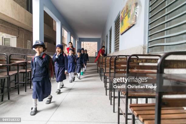 Group of school children in school uniforms that are walking down a hallway at the Saint Mary's High School on February 28, 2014 in Lahore, Pakistan....