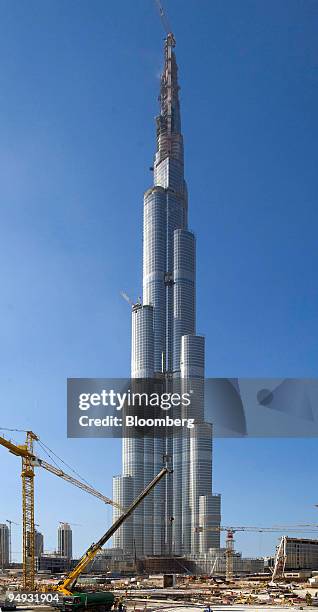 Construction employees work on the Burj Dubai tower complex in Dubai, United Arab Emirates, on Sunday, Nov. 23, 2008. The property bubble in the...