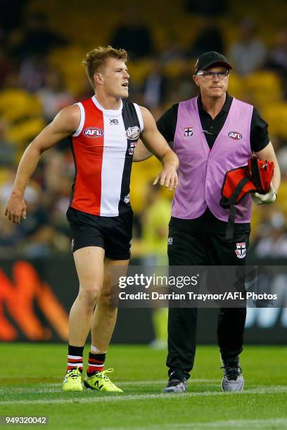 Jack Newnes of the Saints is helped by a trainer after colliding with Dawson Simpson of the Giants during the round five AFL match between the St...