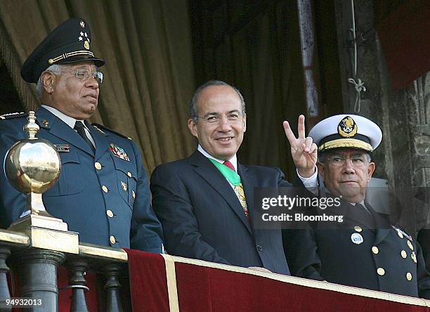 Felipe Calderon, Mexico's president, center, is flanked by Guillermo Galvan, defense minister, left, and Mariano Francisco, minister of the navy, as...