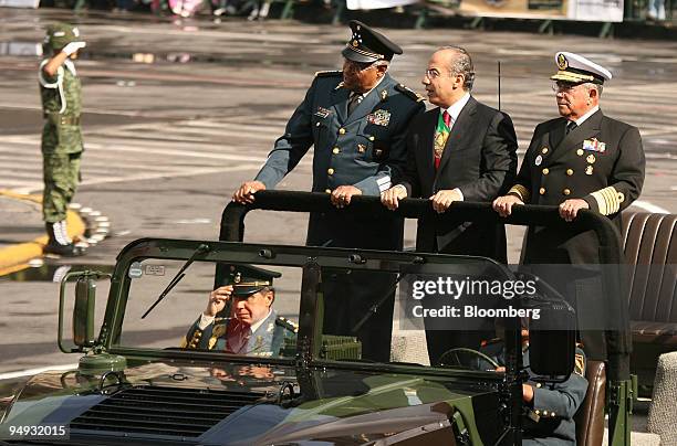 Felipe Calderon, Mexico's president, center, is flanked by Guillermo Galvan, defense minister, left, and Mariano Francisco, minister of the navy,...