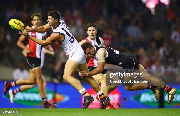 Jonathon Patton of the Giants is tackled by Luke Dunstan of the Saints during the round five AFL match between the St Kilda Saints and the Greater...