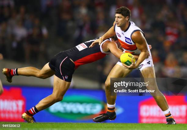 Jonathon Patton of the Giants is tackled by Luke Dunstan of the Saints during the round five AFL match between the St Kilda Saints and the Greater...