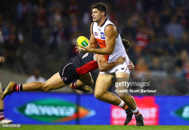Jonathon Patton of the Giants is tackled by Luke Dunstan of the Saints during the round five AFL match between the St Kilda Saints and the Greater...